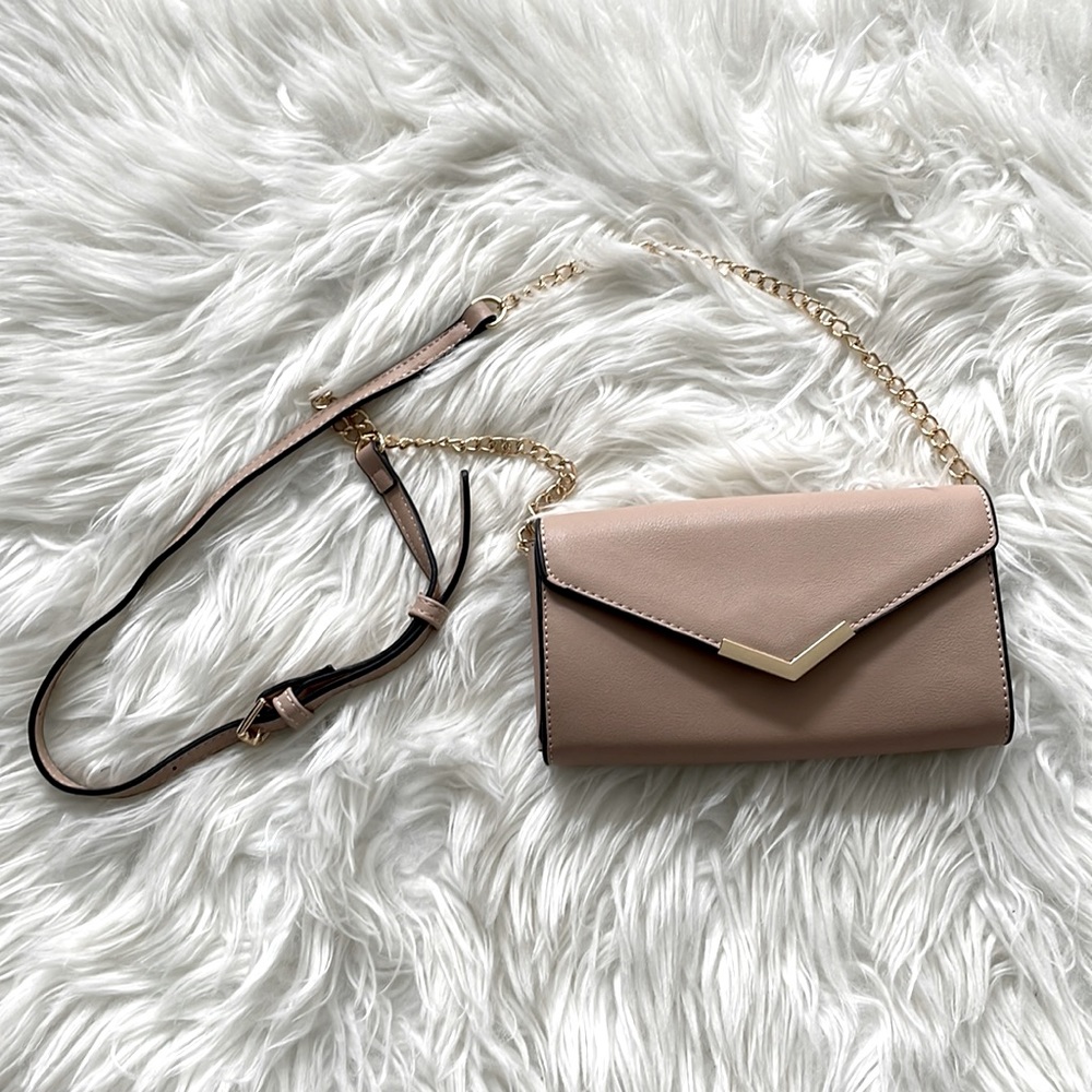 Nude handbag with strap. Comes with zippered pocket, 3 sections, and card slots.